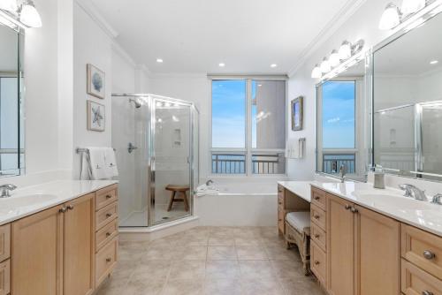 a large bathroom with two sinks and a shower at La Playa 801 in Perdido Key