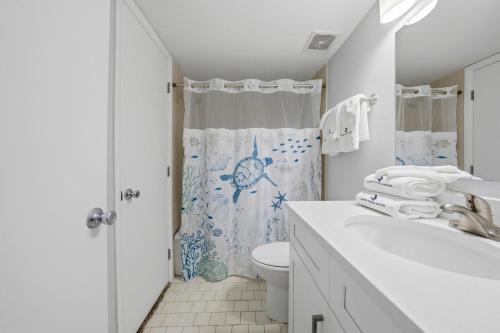 a white bathroom with a toilet and a shower at Perdido Sun 1008 in Perdido Key