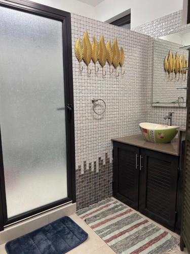 a bathroom with a shower and a sink at Serenity Apartments in Albion