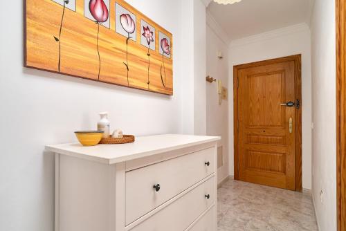 a kitchen with a white counter and a wooden door at Club Oasis Flat in Málaga