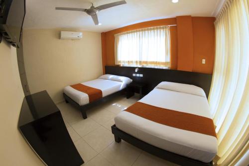 Säng eller sängar i ett rum på Hotel & Suites Domani