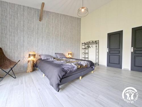 a bedroom with a bed and two lamps on the floor at Au brunet in Saint-Élix-Theux
