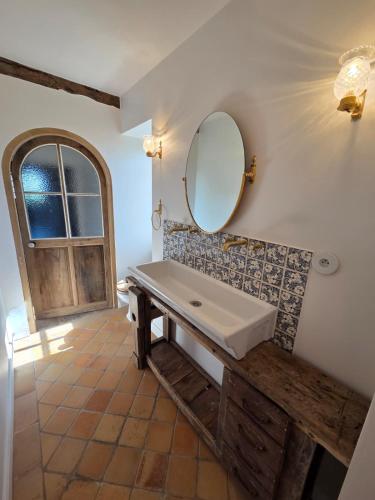 a bathroom with a sink and a mirror on the wall at Château de Beaumanoir in Évran