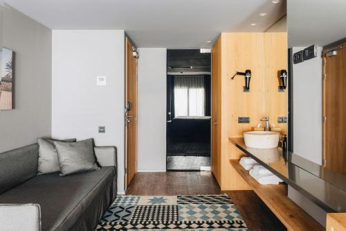 a living room with a couch and a sink at Uma House by Yurbban Trafalgar in Barcelona