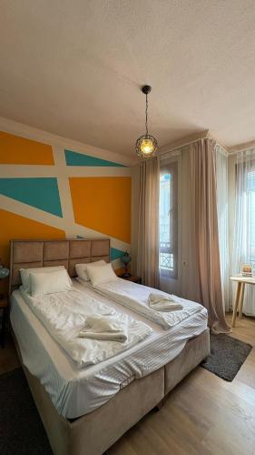 a bedroom with a large bed with a colorful wall at Ehli Keyf Hotel in Istanbul