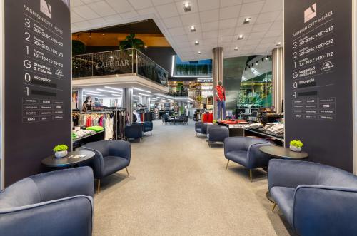 a store with blue chairs and tables in a store at Fashion City Hotel Superior in Budapest