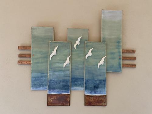 a painting of birds flying over the ocean at The Loft at Design Bank in Milltown Malbay