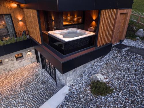 a bath tub on the side of a house at NANI - Mountain Chalet in Saalbach-Hinterglemm