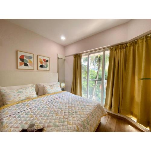 a bedroom with a bed and a large window at Modern 2bed Bandra AreaParkingUnit 2 in Mumbai