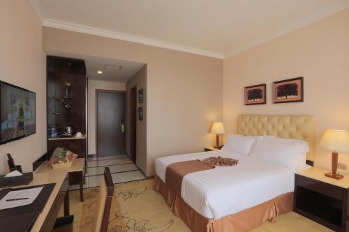 a hotel room with a bed and a desk at Getfam Hotel in Addis Ababa