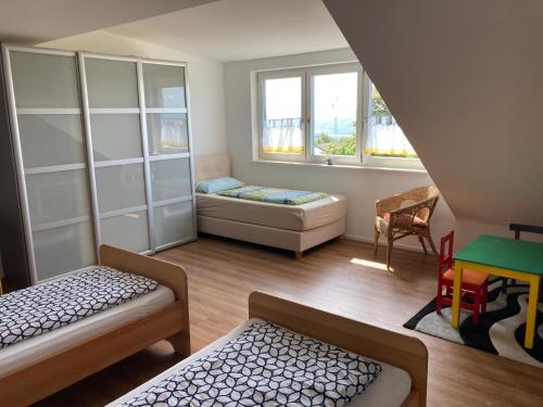 a small room with two beds and a table at kleine Auszeit in Albbruck