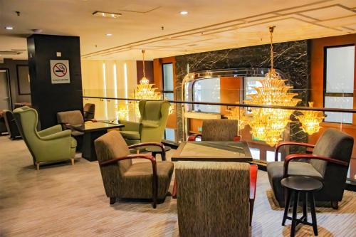 a restaurant with chairs and tables and a dining room at Imperial Heritage Hotel Melaka I City Centre I Free Wifi I Free Parking l Free Club Lounge Access in Malacca