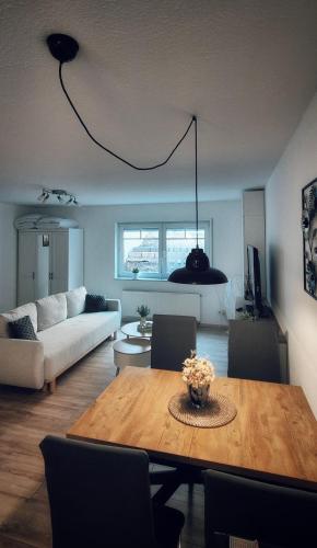 a living room with a table and a couch at FeWoLaqua in Leipzig