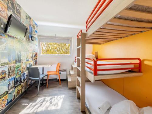 a bedroom with two bunk beds and a table at hôtel F1 Strasbourg Sud La Vigie in Ostwald