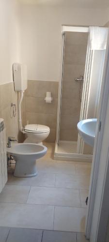 a bathroom with a toilet and a sink at Residence H5 in Piacenza