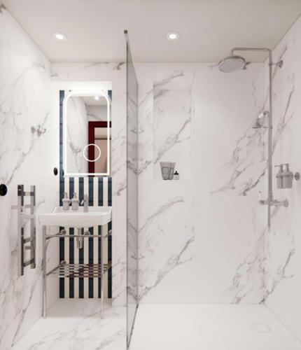 a bathroom with a shower and a sink and a mirror at Grand Hôtel De Turin in Paris