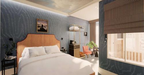 a bedroom with a bed and a blue wall at Grand Hôtel De Turin in Paris