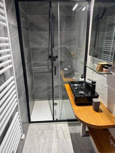a bathroom with a shower and a sink at ILK Residence 3 in Balatonalmádi