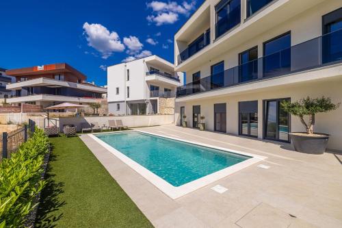 a swimming pool in the backyard of a house at Luxury apartment LaRiv II with pool in Krk