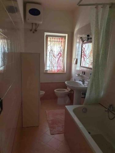 a bathroom with a tub and a sink and a toilet at JV Country in Polignano a Mare