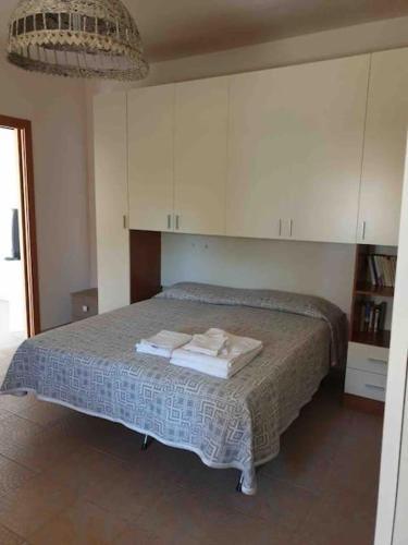 a bedroom with a bed with towels on it at JV Country in Polignano a Mare