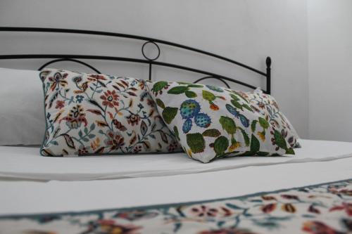 a bed with two pillows on top of it at Baia dei Fenici in Birgi Vecchi