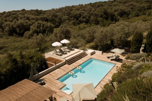 an overhead view of a swimming pool in a resort at L'Hostellerie du Moulin des Oliviers in Olmeto