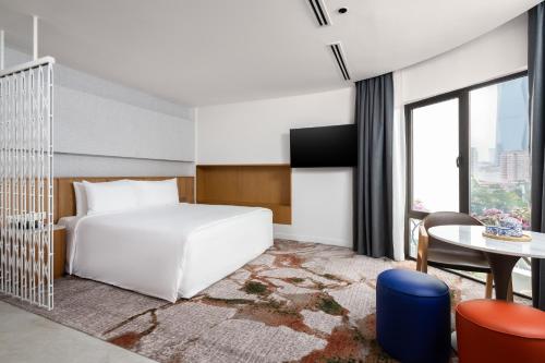 a hotel room with a bed and a table at The Federal Kuala Lumpur in Kuala Lumpur