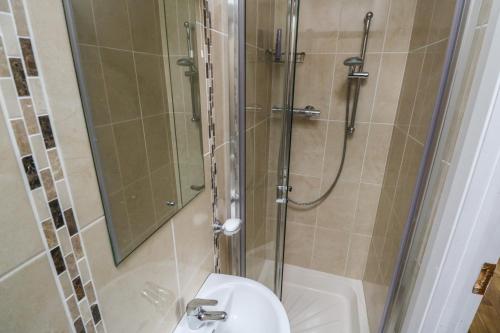a bathroom with a shower and a toilet and a sink at River House in Ballina