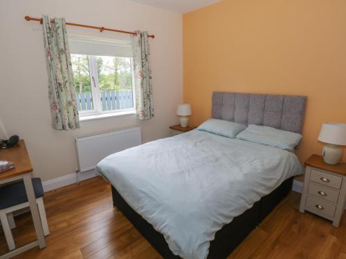 a bedroom with a large bed with a window at River House in Ballina