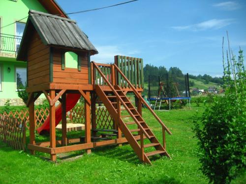 a playground with a slide and a play house at Zielone Zacisze in Krościenko