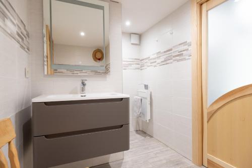 a bathroom with a sink and a mirror at Chambre d'hôtes Basinroche in Saulxures-sur-Moselotte