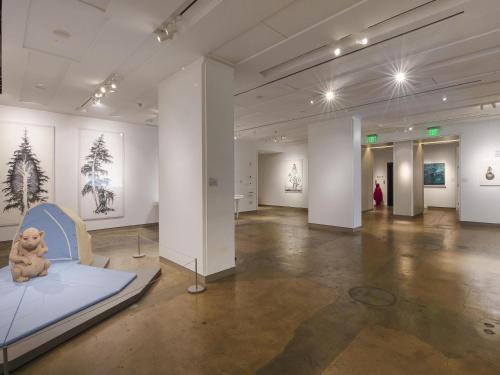 a room with a teddy bear sitting on a bed in a museum at 21c Museum Hotel Durham in Durham