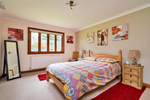 a bedroom with a bed and a dresser and a mirror at Finest Retreats - The Grove Annexe in Craven Arms