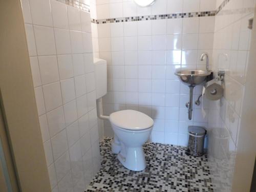 a bathroom with a toilet and a sink at Villa Althaus in Medebach