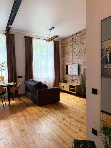 a living room with a couch and a table at Urban Loft Studio 33 in Daugavpils