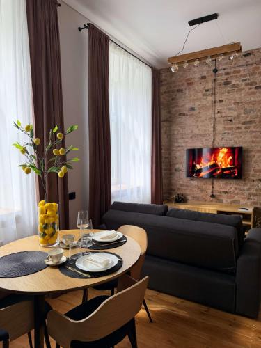a living room with a table and a couch at Urban Loft Studio 33 in Daugavpils