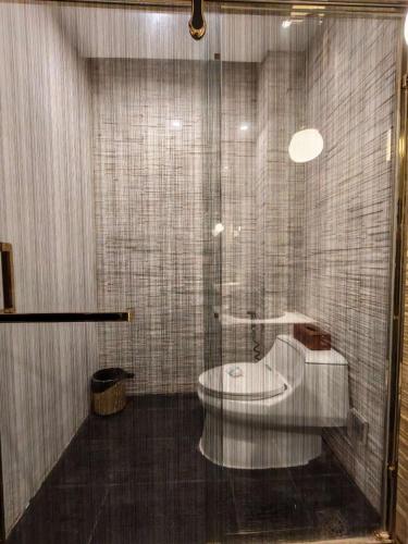 a bathroom with a toilet and a glass shower at Vangvieng Lina hotel in Vang Vieng