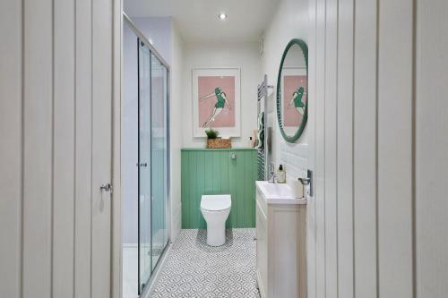 a bathroom with a toilet and a sink at The Bamburgh Bolthole in Bamburgh