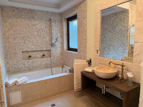 a bathroom with a large tub and a sink at Luxury villas and golf GV6 in Balchik