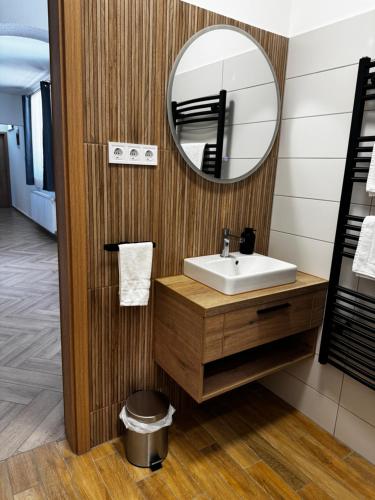 a bathroom with a sink and a mirror at Dominó Apartman in Gelse