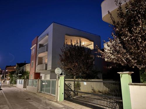 a building with a fence in front of it at Come a Casa in Montesilvano