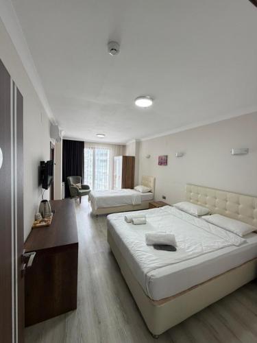 a large bedroom with two beds and a desk at LUXOR RESIDENCE in Trabzon