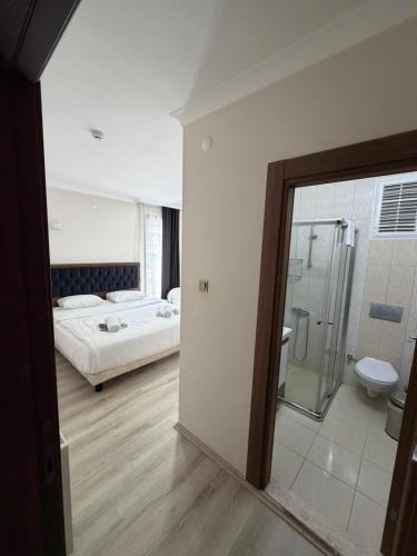 a room with a bedroom with a bed and a shower at LUXOR RESIDENCE in Trabzon