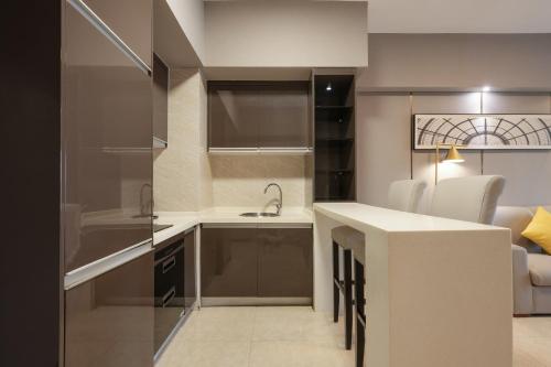 a small kitchen with a sink and a counter at Foshan Poltton International Serviced Apartment in Foshan