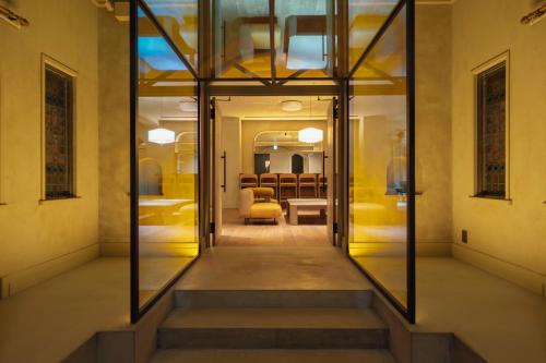 a hallway with glass doors leading to a room at SOSHIJI Arashiyama in Kyoto