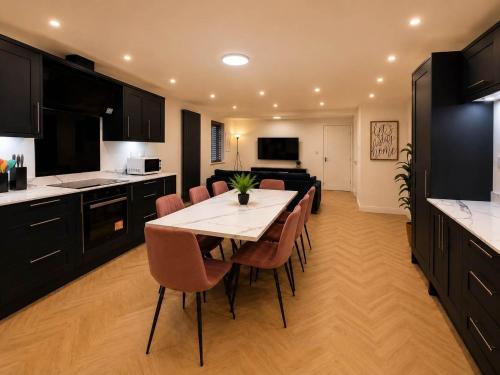 a kitchen with a table and chairs and a living room at The Blackhorse Windsor in Dorney