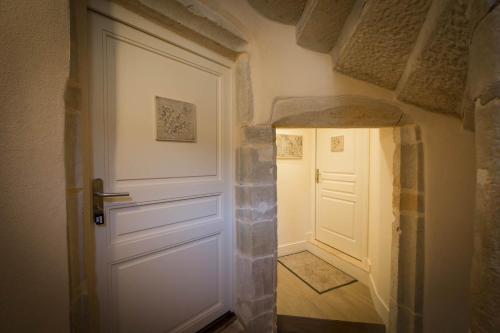 a hallway with a white door in a room at Le Cara in Beaune