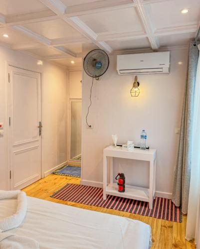 a room with a white bed and a white table at Youssef Nile Boat in Luxor