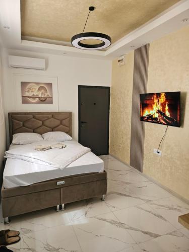 a bedroom with a bed and a tv on a wall at Studio centar Lazic 1 in Šid
